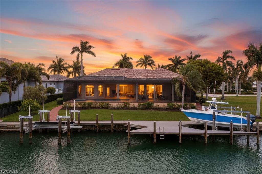 Waterfront home with private dock and boat lift at sunset, 1589 Caxambas Ct, Marco Island